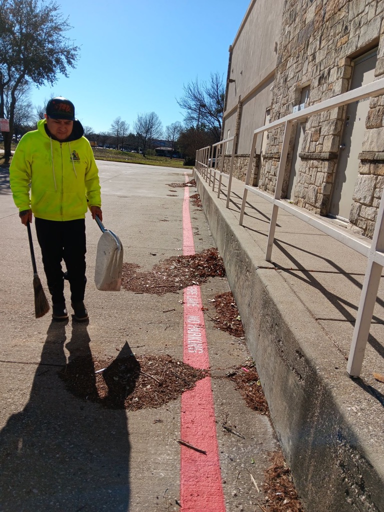 Property Zeus porter sweeping the fire lane curb line at a DFW shopping center